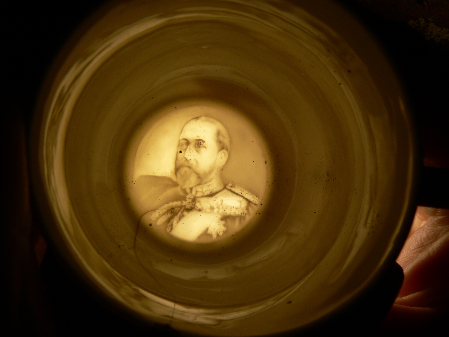 Photograph of translucent image of Edward VII in base of teacup