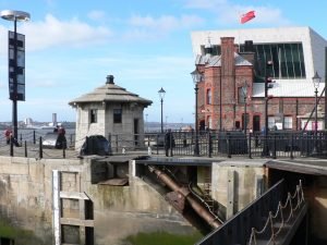 Photo of a gateman hut at albert Dock, with the Museum of Liverpool in the background